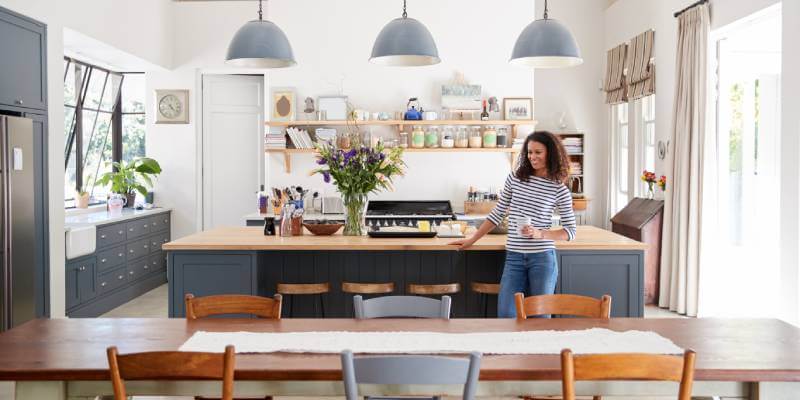 Woman In Modern Kitchen Diner