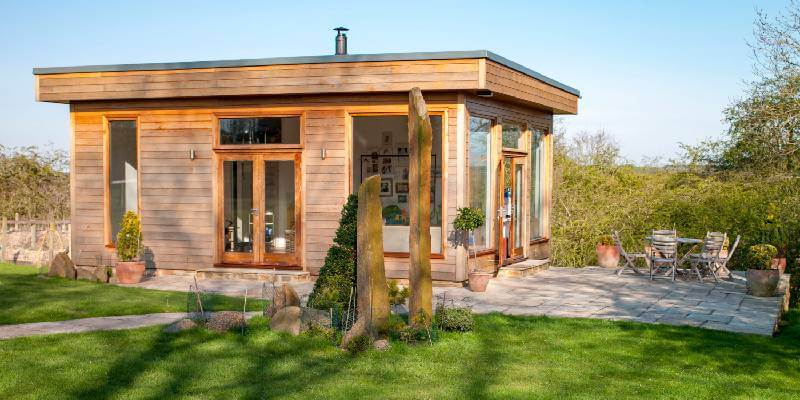 Wood panel office building with stone patio